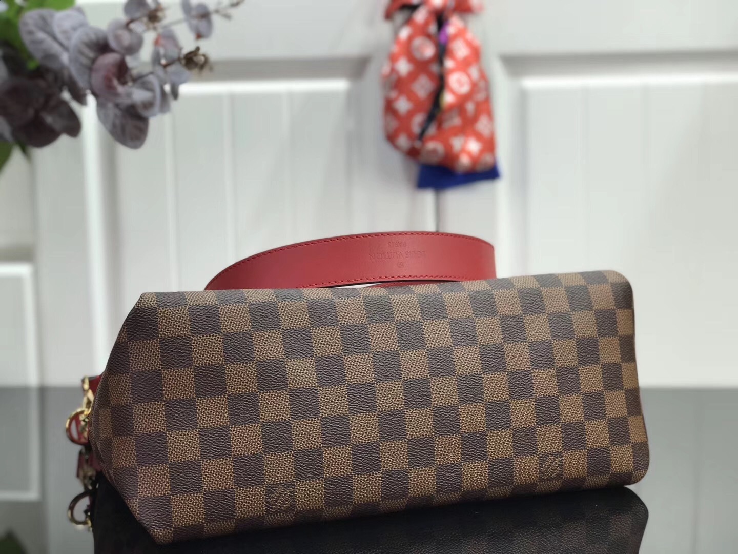 LV Beaubourg MM handbag made from Damier Ebene canvas with red leather details.
