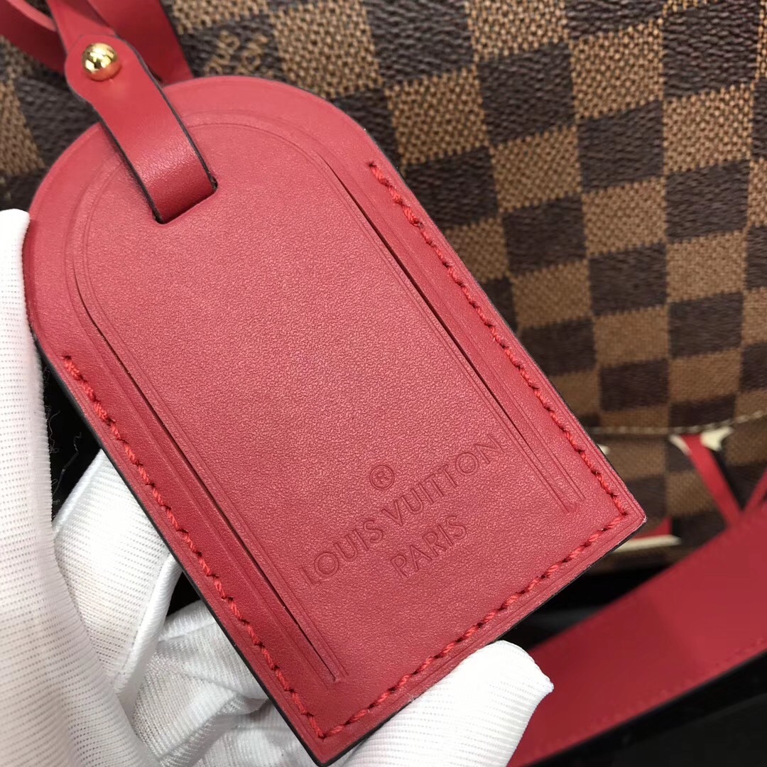 LV Beaubourg MM handbag made from Damier Ebene canvas with red leather details.
