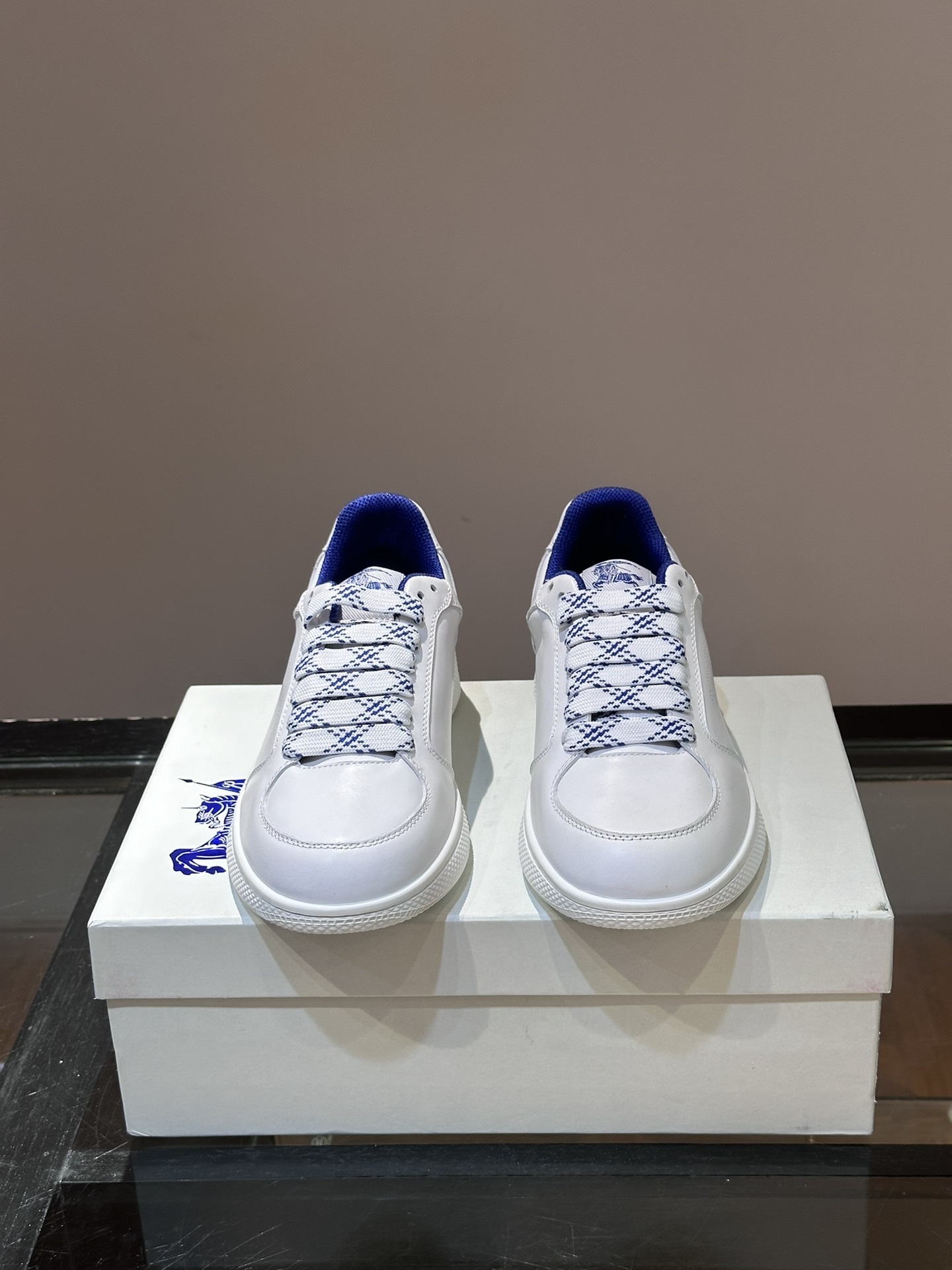 Burberry Stock leather sneakers feature a white calf leather upper, the Equestrian Knight Design perforated on the sides, and a rubber sole.