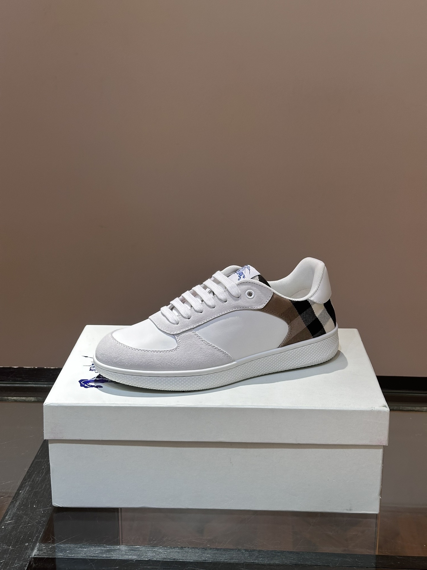 Burberry Terrace sneakers, a style crafted in smooth calf leather with a woven check panel.