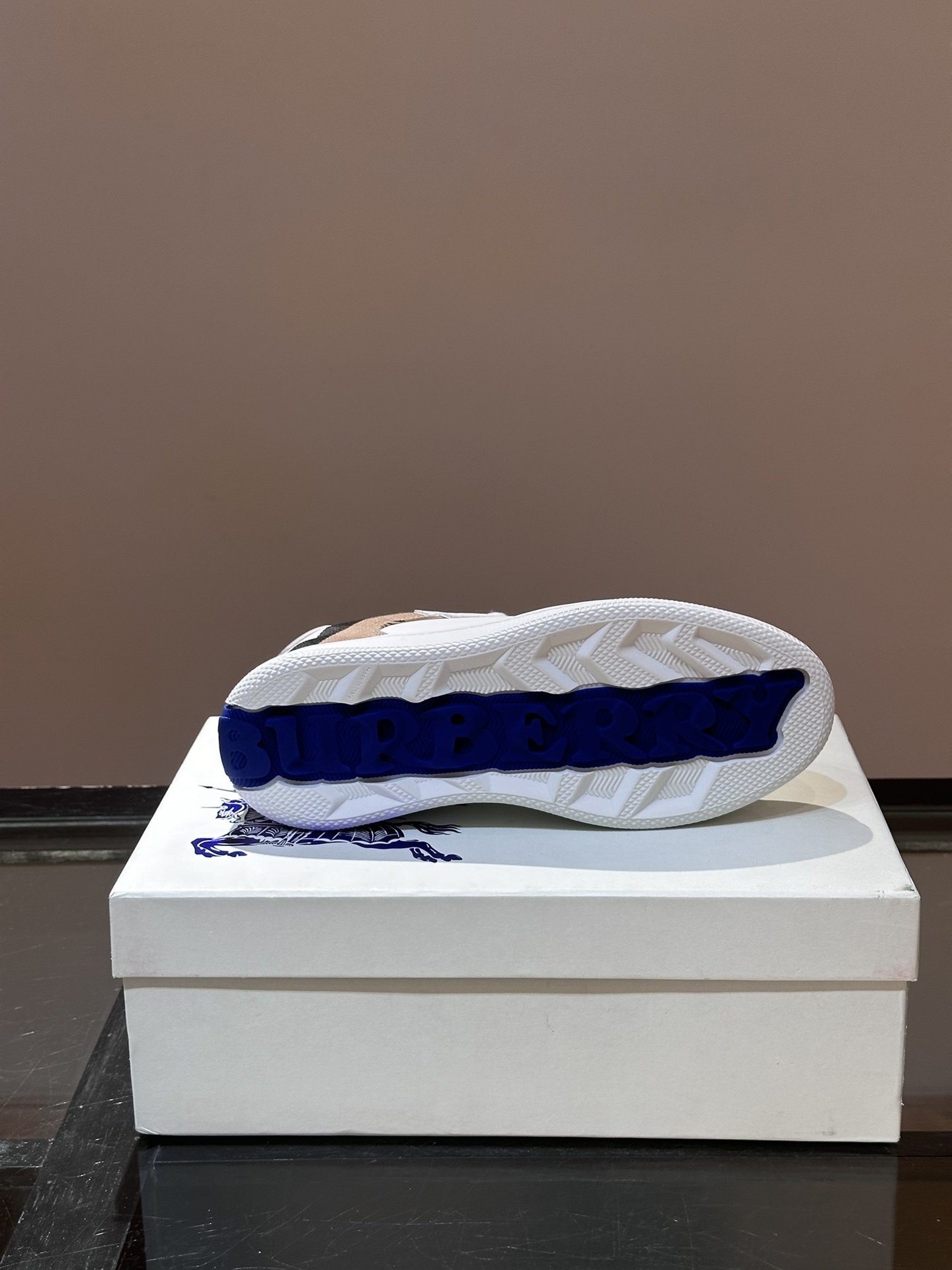 Burberry Terrace sneakers, a style crafted in smooth calf leather with a woven check panel.