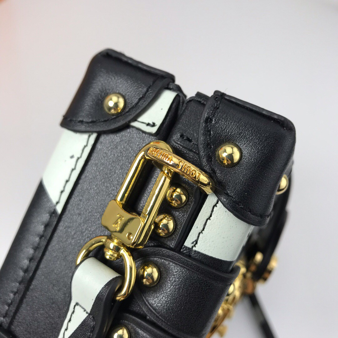 LV Petite Malle handbag is inspired by the brand's historic trunks, featuring a distinctive structured shape, gold-tone hardware, and an S-lock clasp.