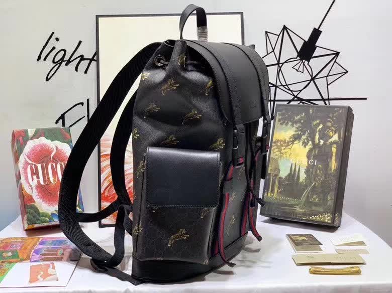 Gucci GG Supreme Backpack featuring a tiger print design.