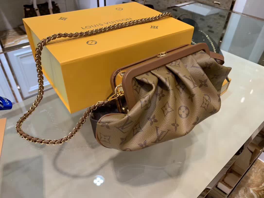 LV Boursicot EW bag is a vintage-inspired pouch crafted from monogram and reverse monogram coated canvas with leather-covered frame details