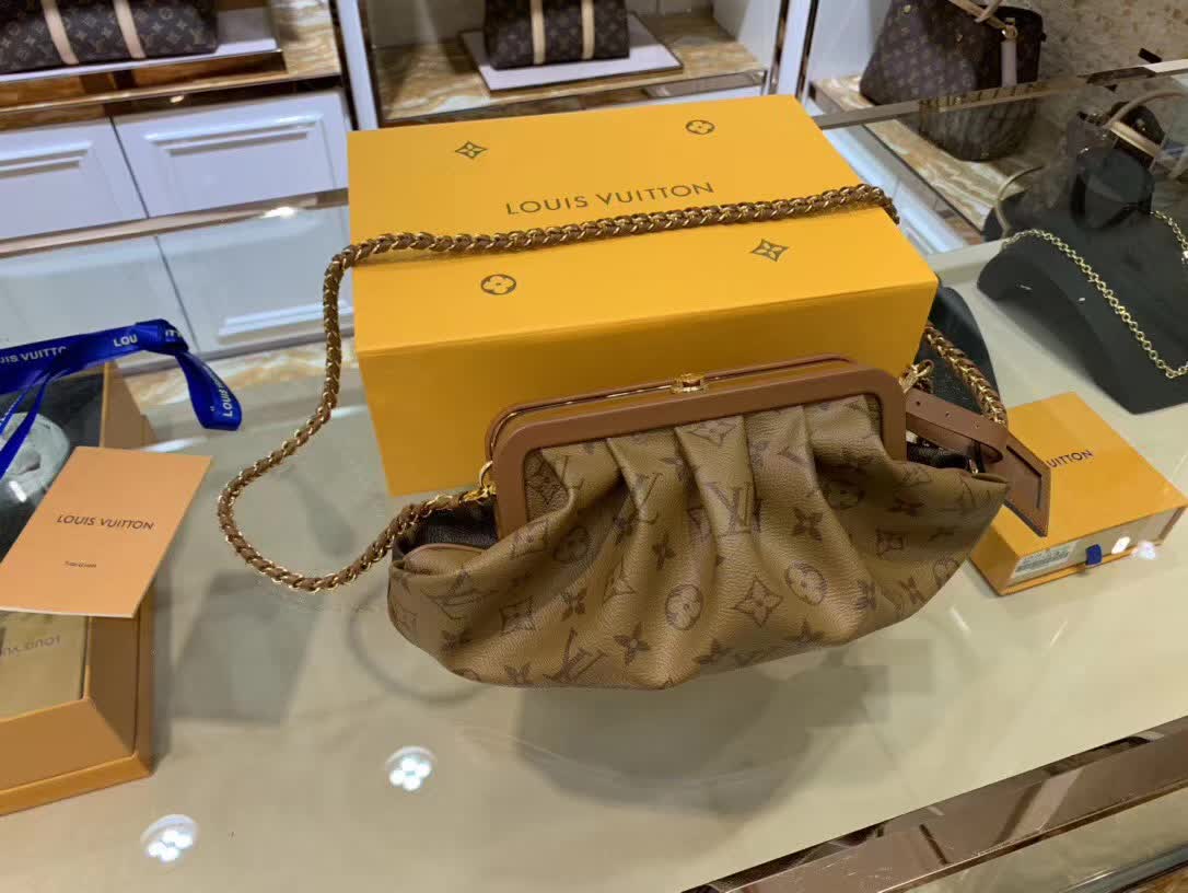 LV Boursicot EW bag is a vintage-inspired pouch crafted from monogram and reverse monogram coated canvas with leather-covered frame details