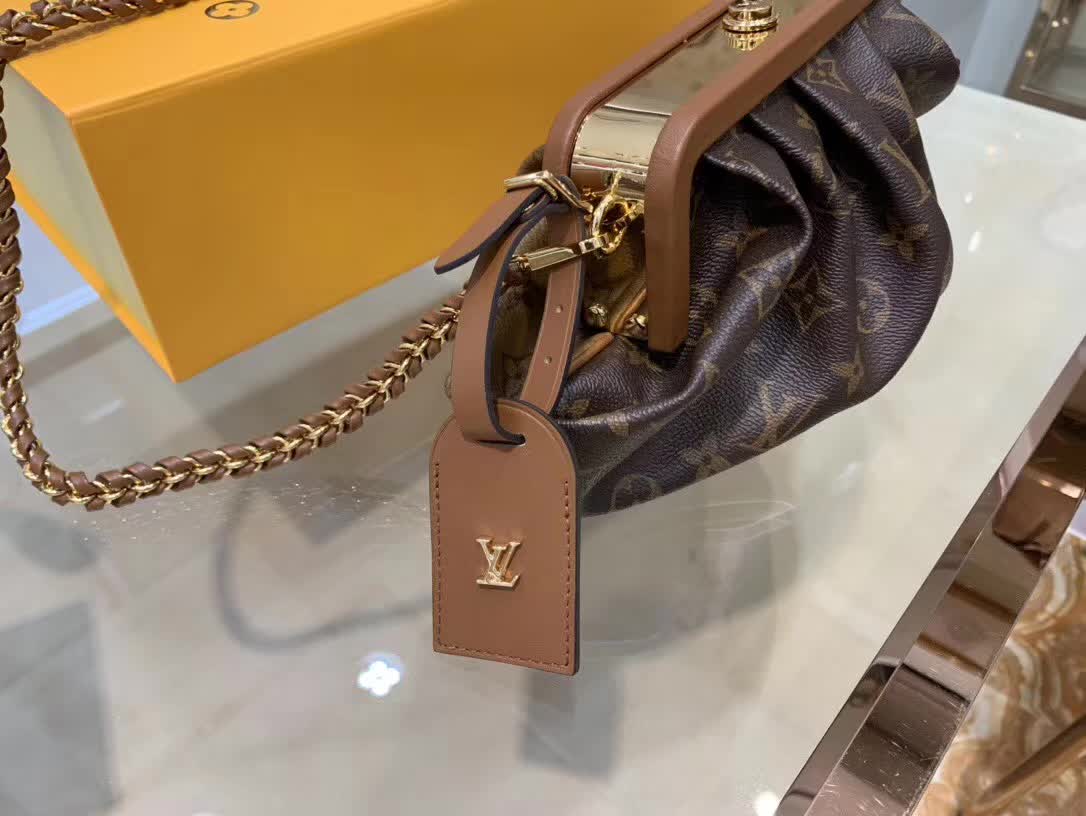 LV Boursicot EW bag is a vintage-inspired pouch crafted from monogram and reverse monogram coated canvas with leather-covered frame details