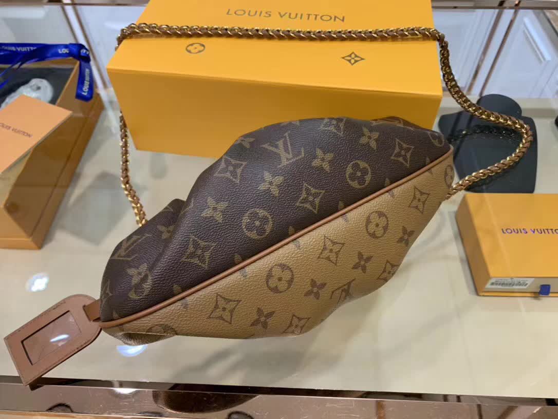 LV Boursicot EW bag is a vintage-inspired pouch crafted from monogram and reverse monogram coated canvas with leather-covered frame details