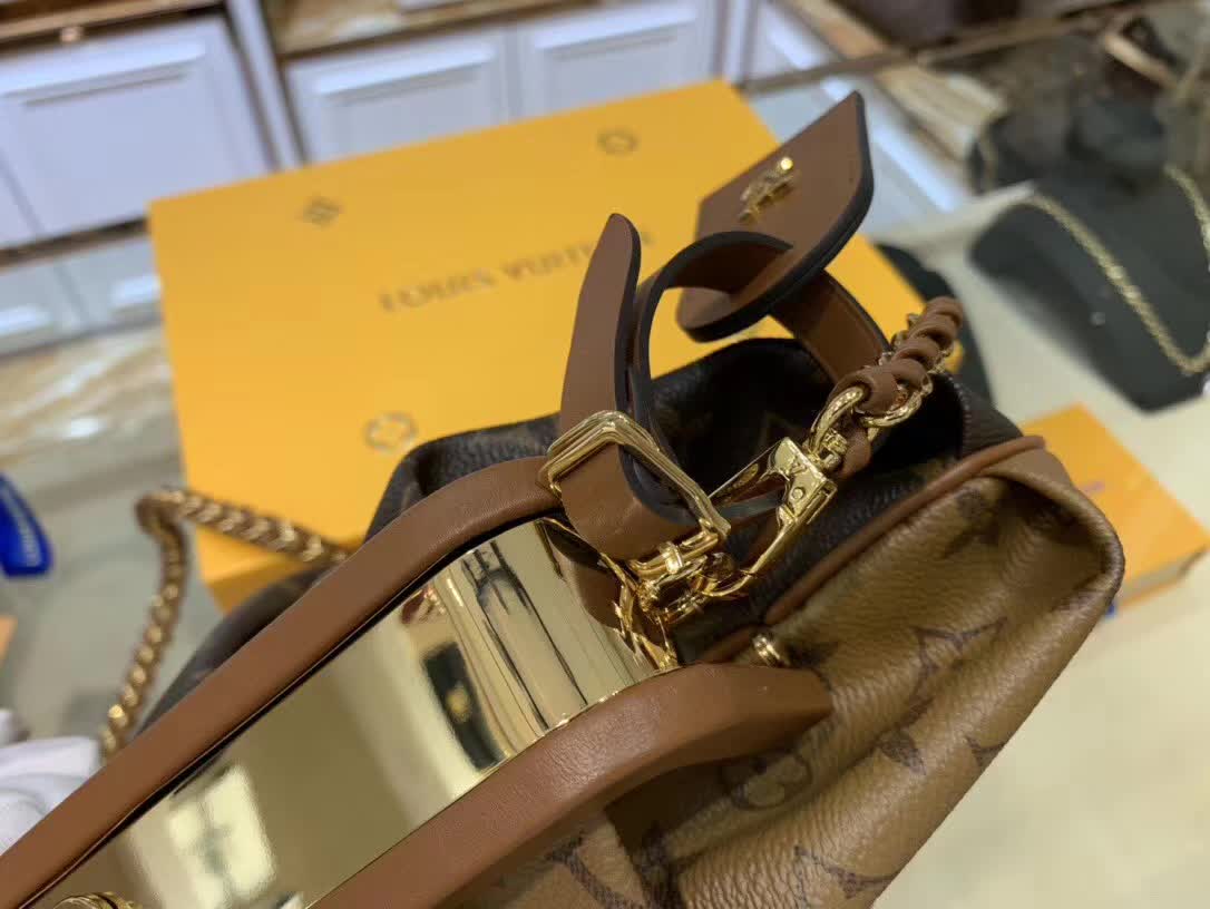 LV Boursicot EW bag is a vintage-inspired pouch crafted from monogram and reverse monogram coated canvas with leather-covered frame details