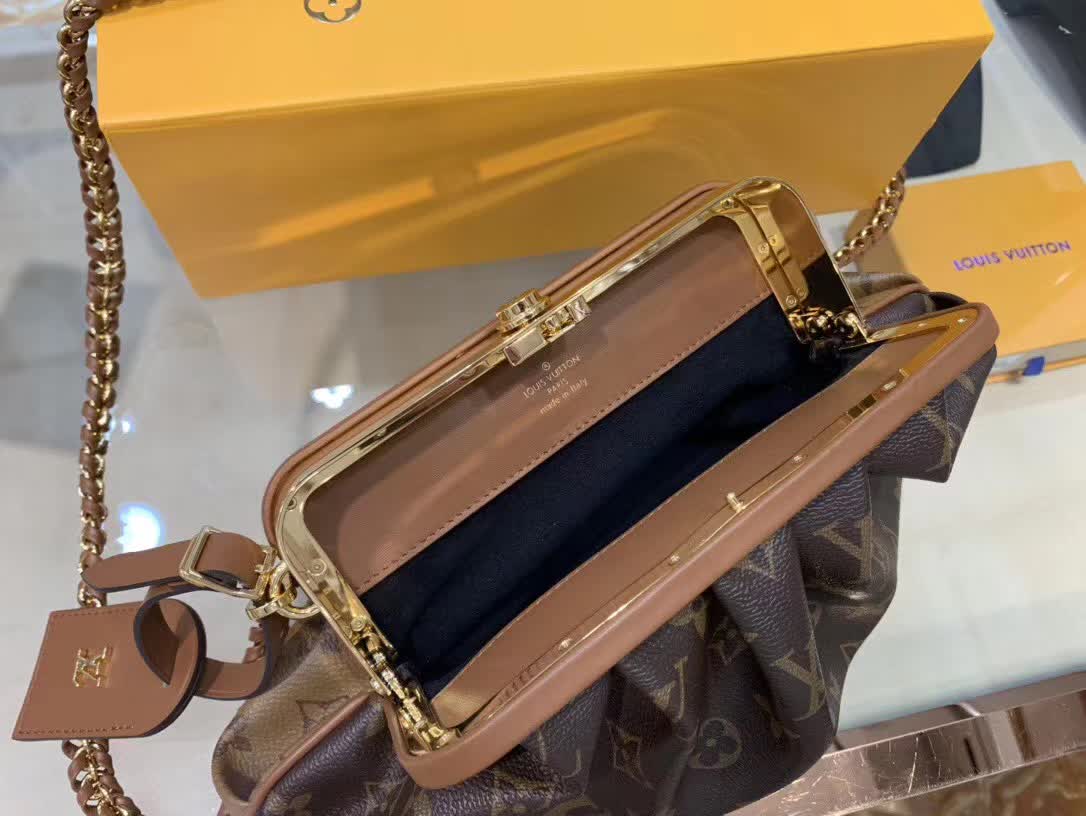 LV Boursicot EW bag is a vintage-inspired pouch crafted from monogram and reverse monogram coated canvas with leather-covered frame details