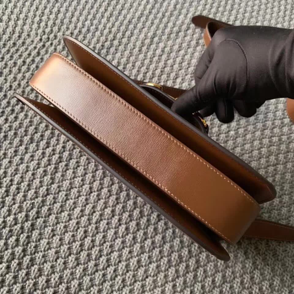 Gucci Horsebit 1955 shoulder bag, featuring the brand's iconic GG monogram canvas with brown leather trim and gold-tone horsebit hardware