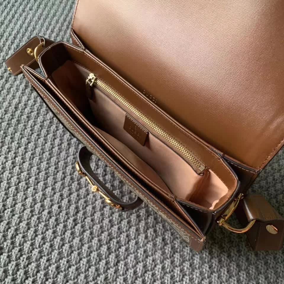 Gucci Horsebit 1955 shoulder bag, featuring the brand's iconic GG monogram canvas with brown leather trim and gold-tone horsebit hardware