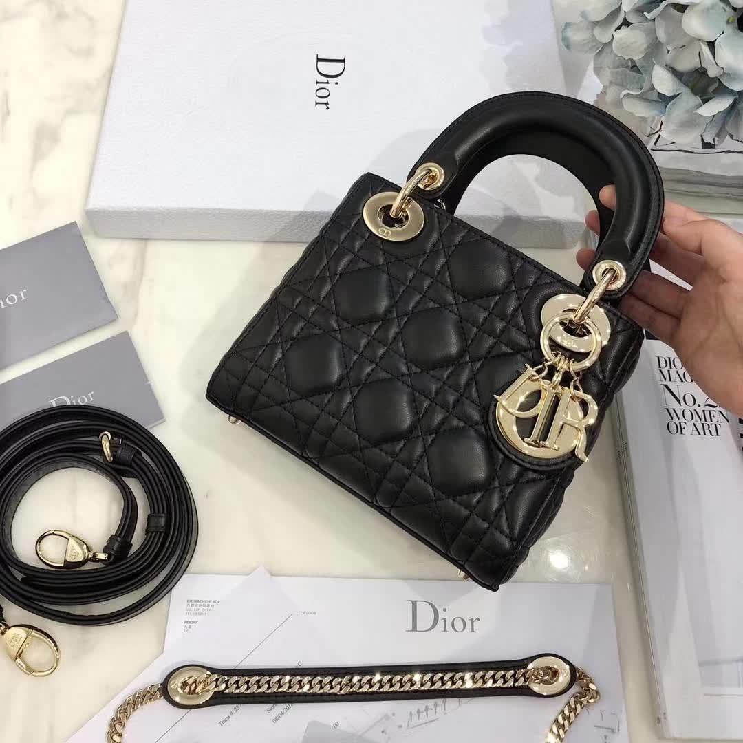 christian dior black quilted lambskin leather Lady Dior bag featuring distinctive Cannage stitching and pale gold-finish metal D.I.O.R. charms