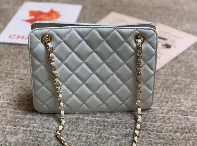 Chanel Calfskin Quilted CC Chain Accordion Tote featuring a diamond-quilted leather body and a distinctive leather-threaded gold chain Chanel CC logo on the front