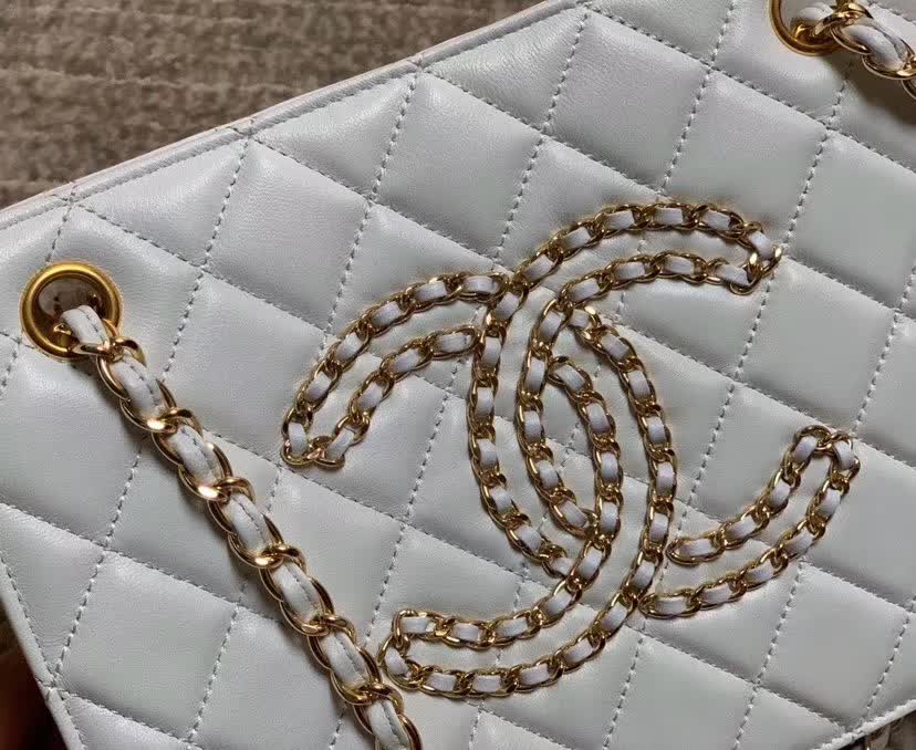 Chanel Calfskin Quilted CC Chain Accordion Tote featuring a diamond-quilted leather body and a distinctive leather-threaded gold chain Chanel CC logo on the front