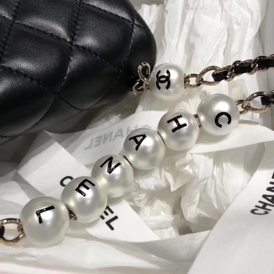 Chanel My Precious Pearls Chain Flap Bag crafted from black lambskin leather and featuring gold-toned hardware