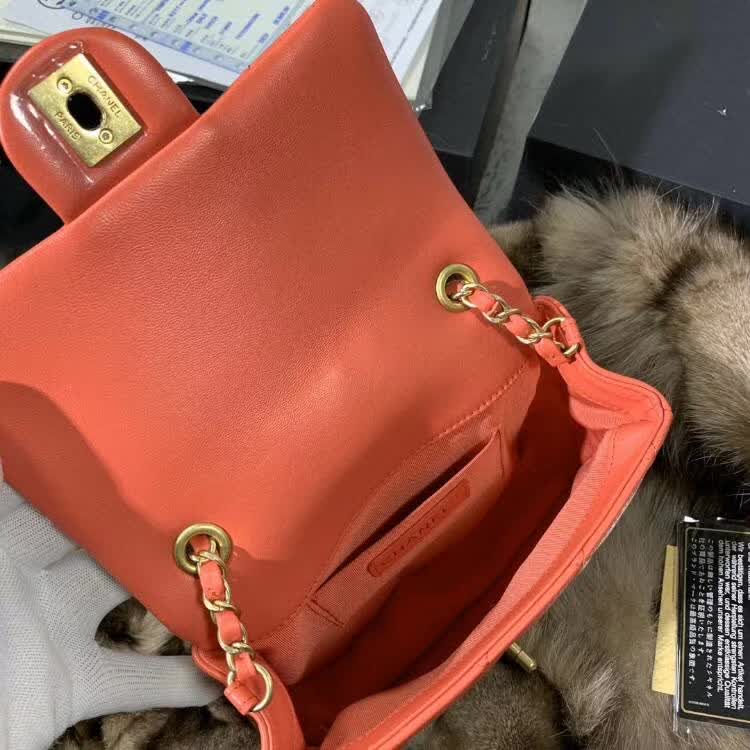 Chanel In The Loop Quilted Lambskin Small Flap Bag in a vibrant red or coral color