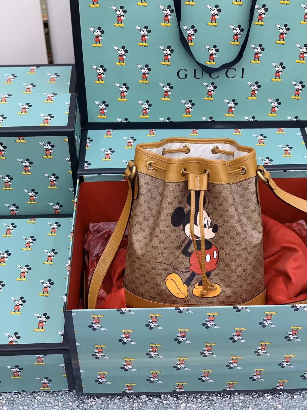 Gucci x Disney Mini GG Supreme Bucket Bag featuring a Mickey Mouse print