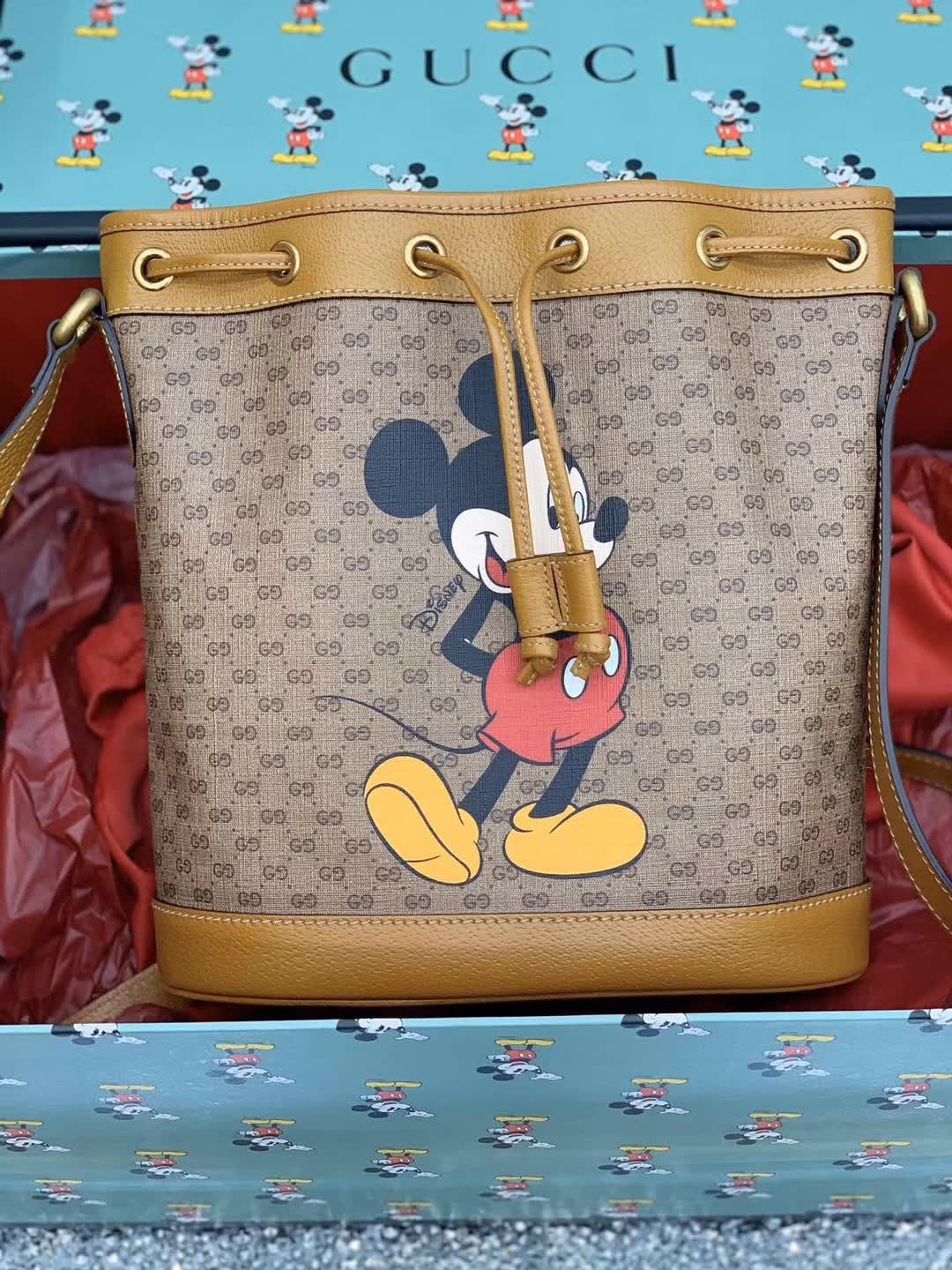 Gucci x Disney Mini GG Supreme Bucket Bag featuring a Mickey Mouse print