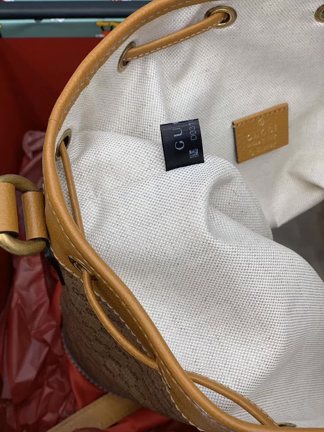 Gucci x Disney Mini GG Supreme Bucket Bag featuring a Mickey Mouse print