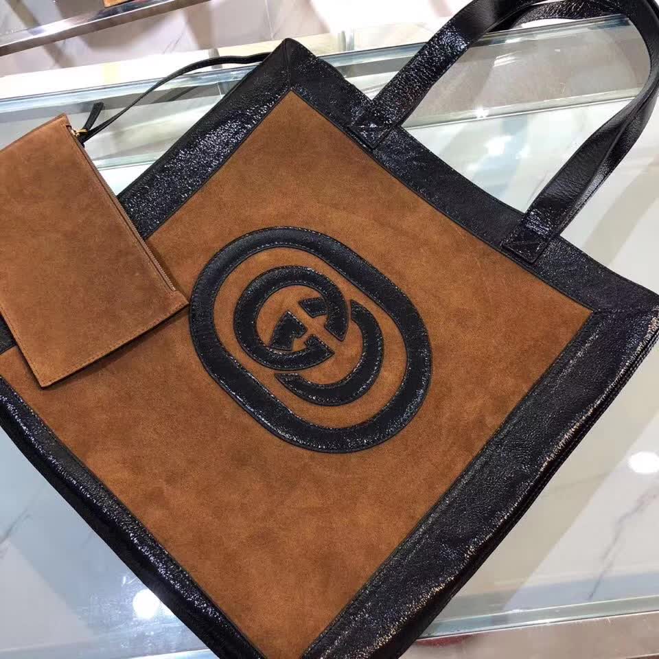 Gucci Ophidia tote bag is crafted from brown suede with black patent leather