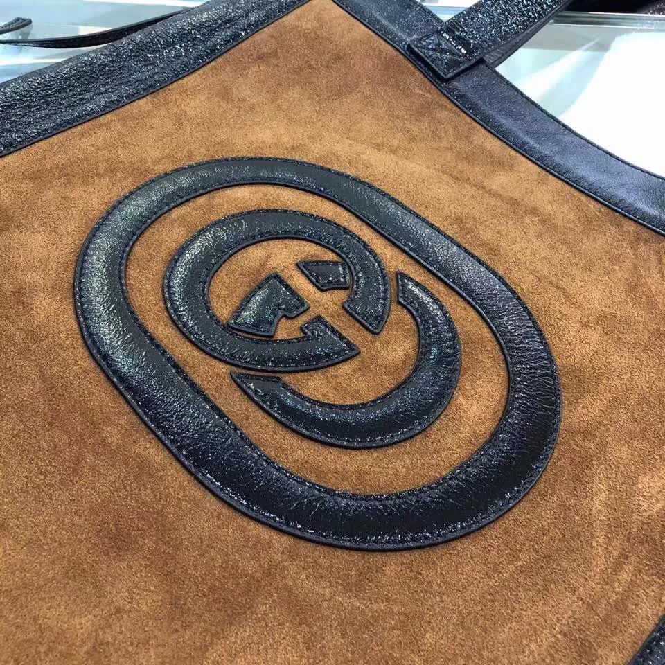 Gucci Ophidia tote bag is crafted from brown suede with black patent leather