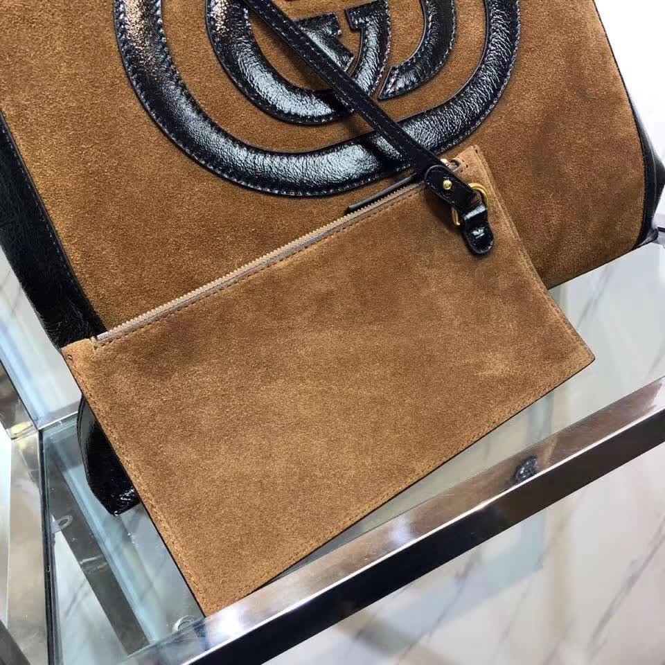 Gucci Ophidia tote bag is crafted from brown suede with black patent leather