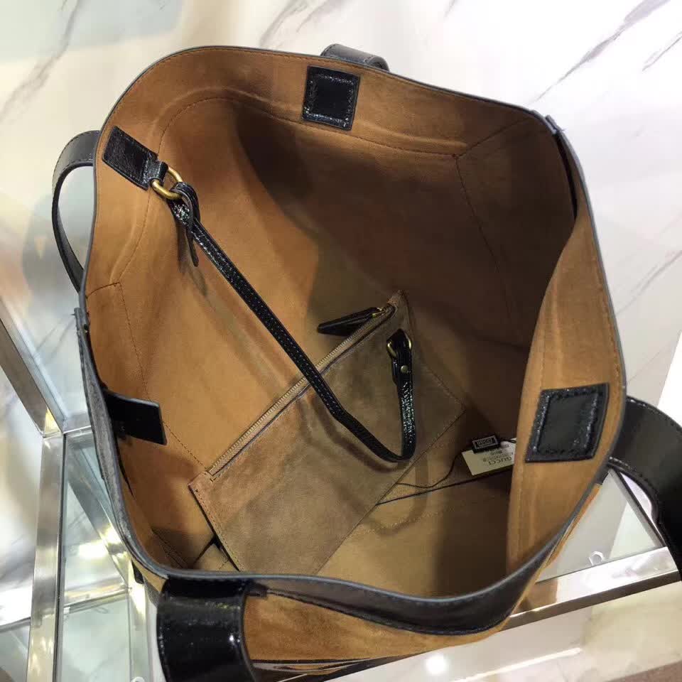 Gucci Ophidia tote bag is crafted from brown suede with black patent leather