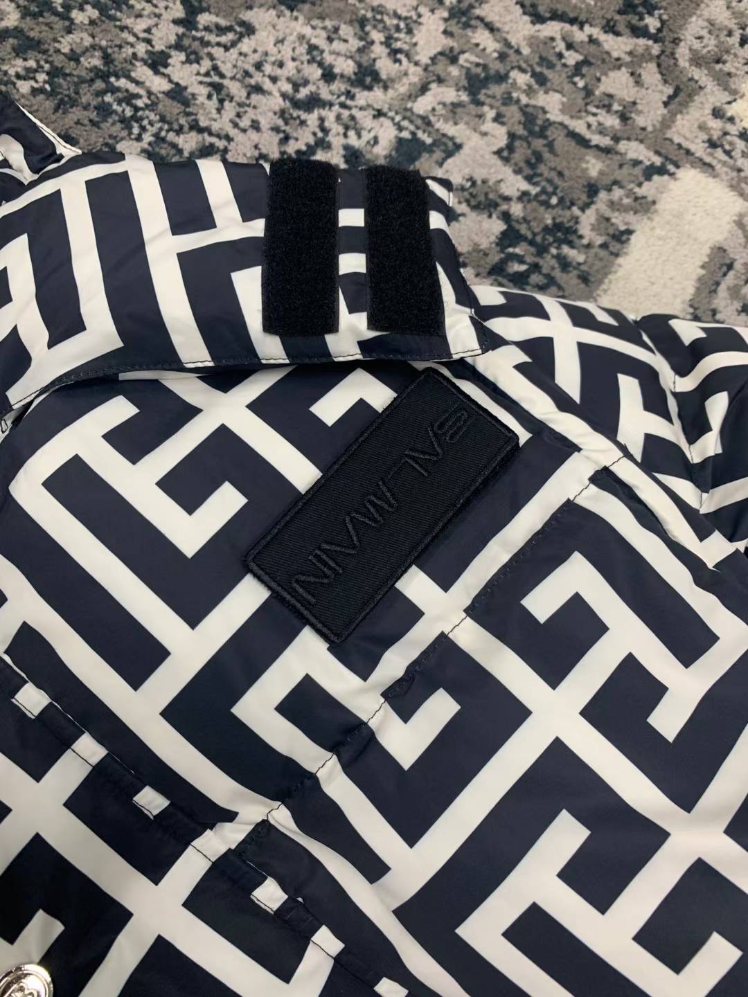 Balmain Maxi Monogram Quilted Jacket, a versatile luxury piece featuring detachable sleeves that allow it to be worn as a vest.