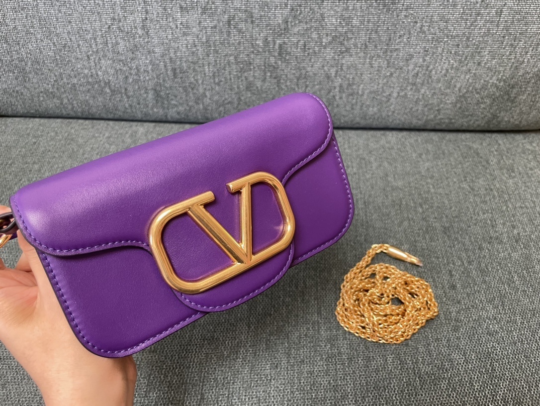 Valentino Garavani Locò small leather shoulder bag in purple with gold-tone hardware