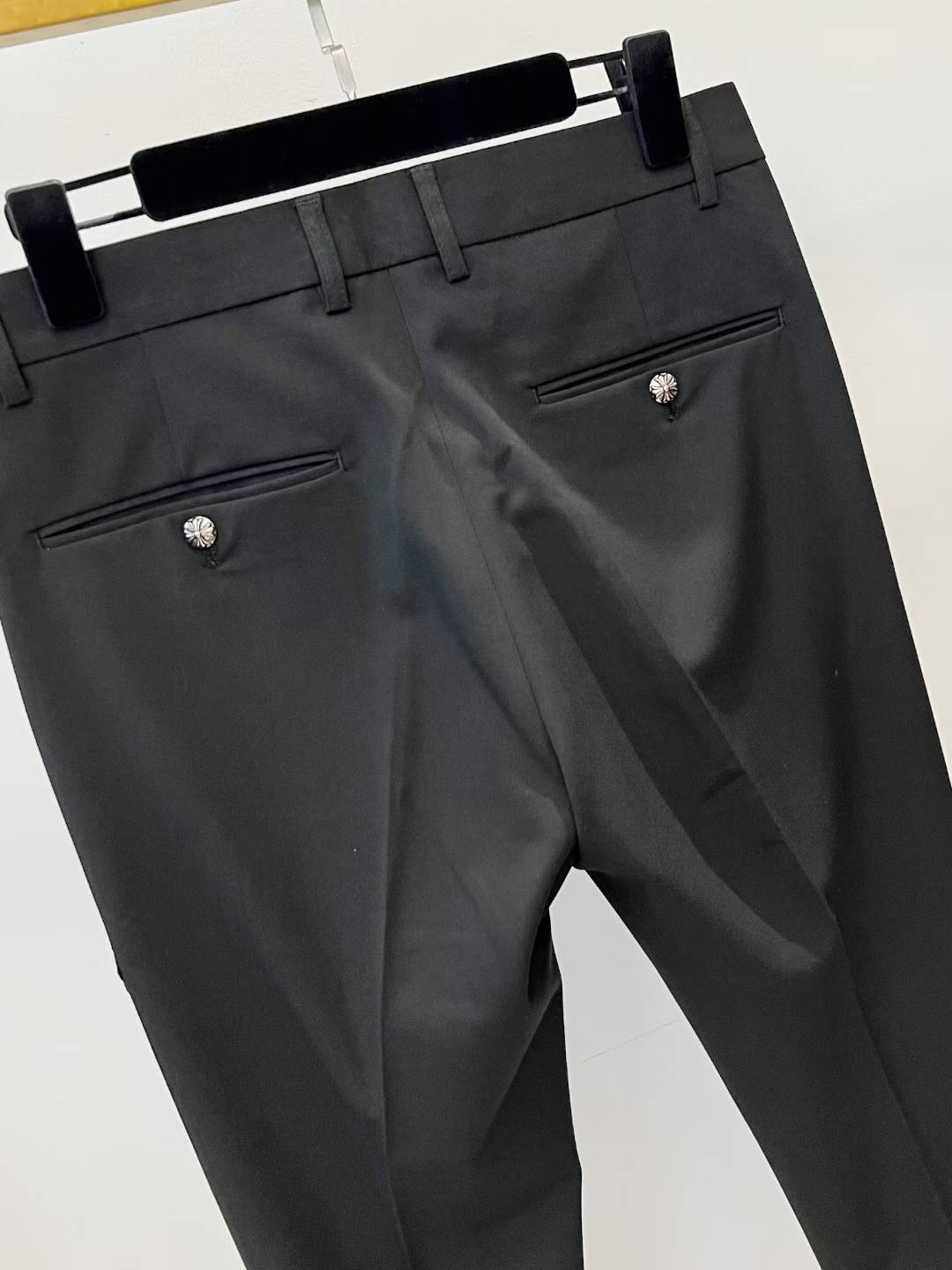 chrome hearts black trousers feature decorative patches and embroidery resembling a luxury designer pair such as those from Philipp Plein