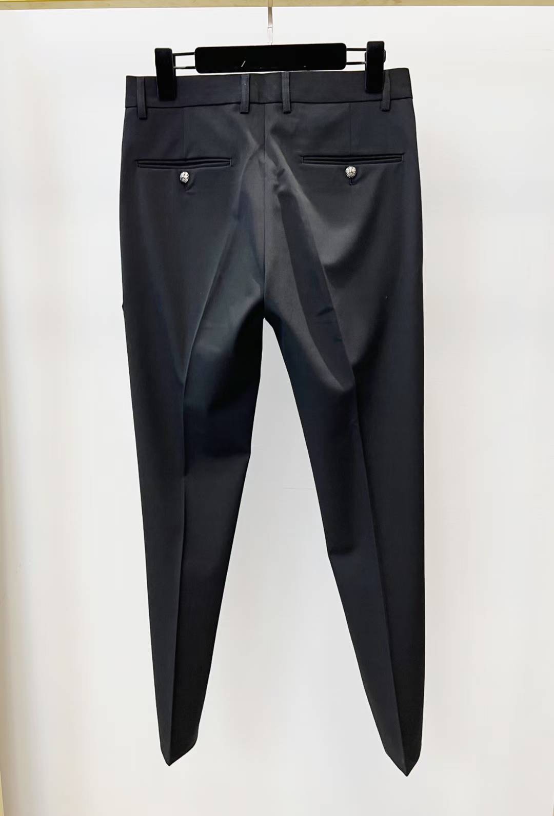 chrome hearts black trousers feature decorative patches and embroidery resembling a luxury designer pair such as those from Philipp Plein