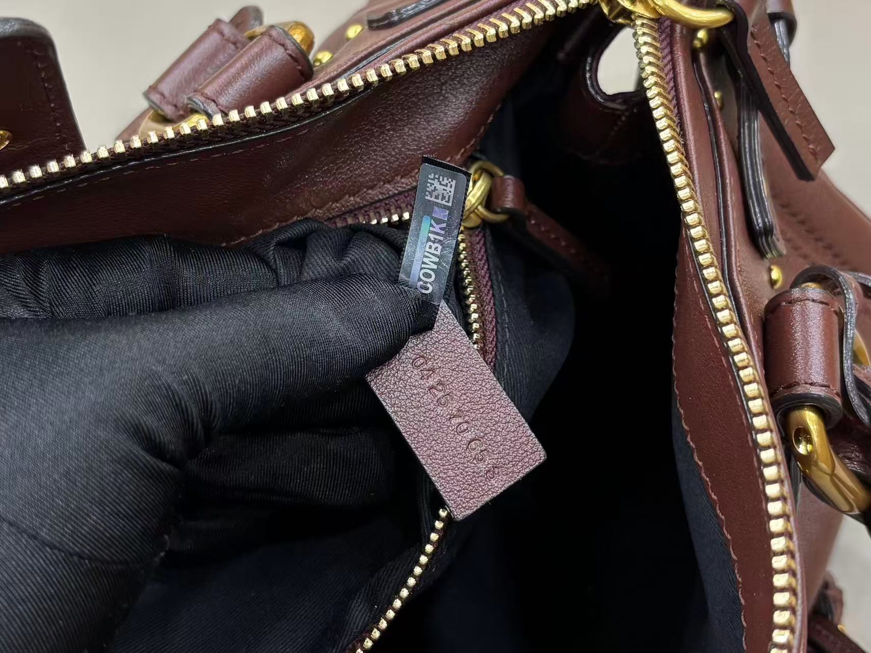 Chloe Paddington bag in Crafty Brown featuring the signature oversized gold padlock, dual top handles, and grained buffalo leather