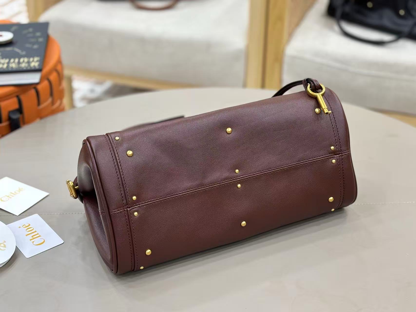 Chloe Paddington bag in Crafty Brown featuring the signature oversized gold padlock, dual top handles, and grained buffalo leather