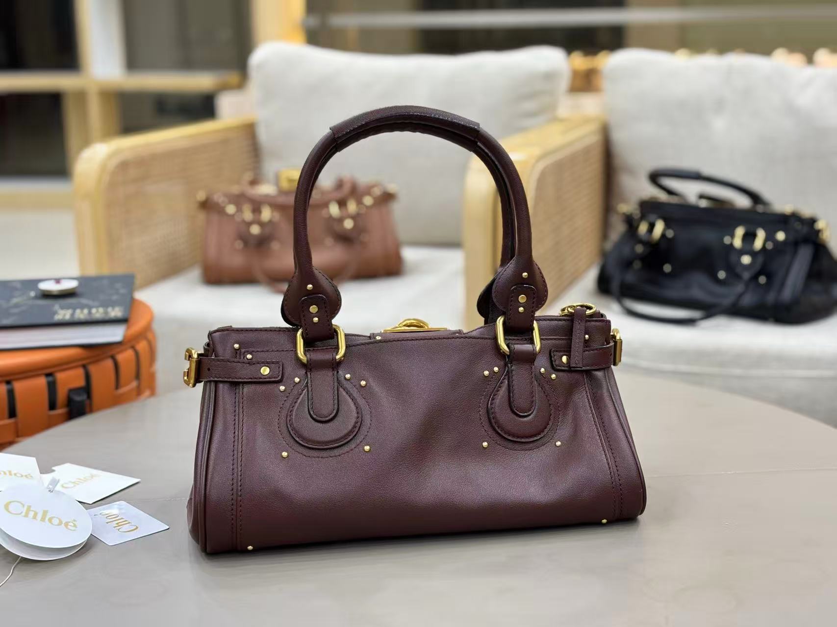 Chloe Paddington bag in Crafty Brown featuring the signature oversized gold padlock, dual top handles, and grained buffalo leather