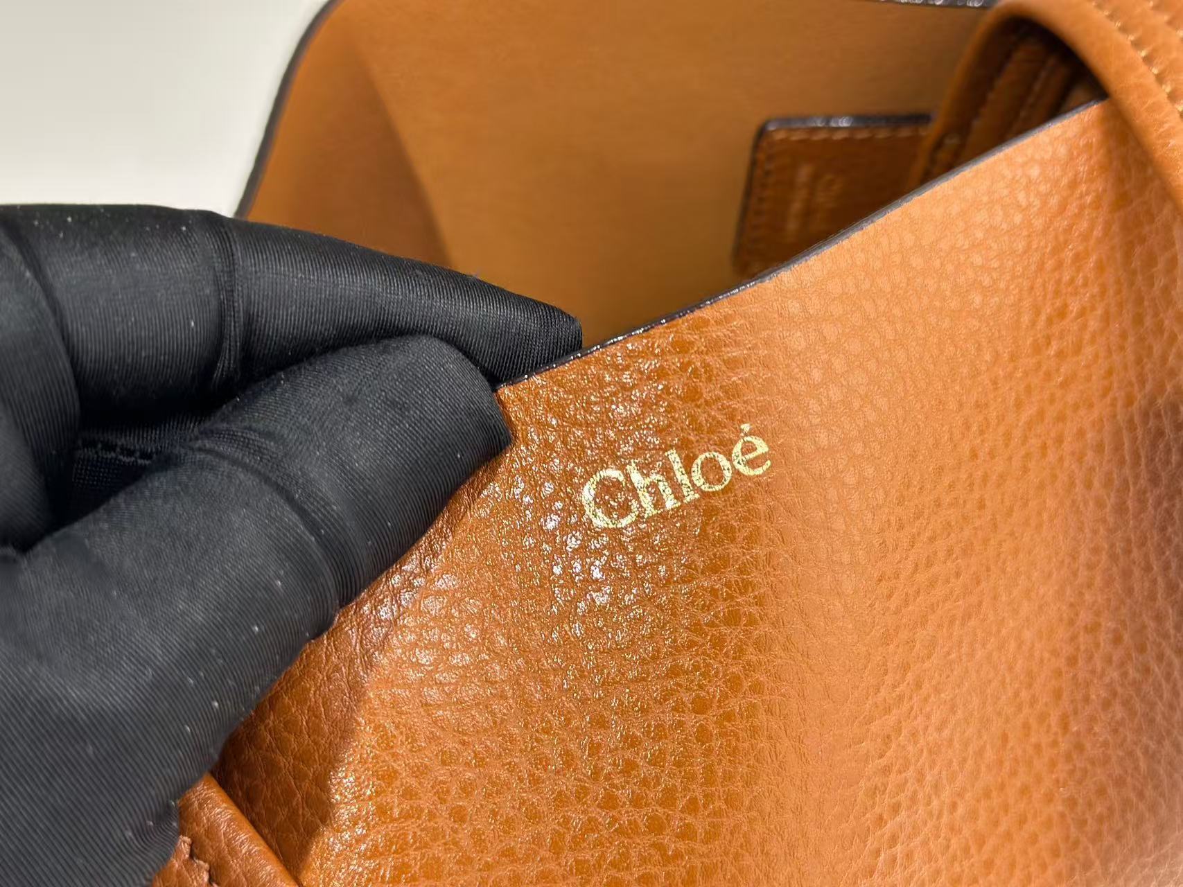 Chloe Small Spin Tote Bag, crafted from grained leather and featuring a distinctive dangling charm.