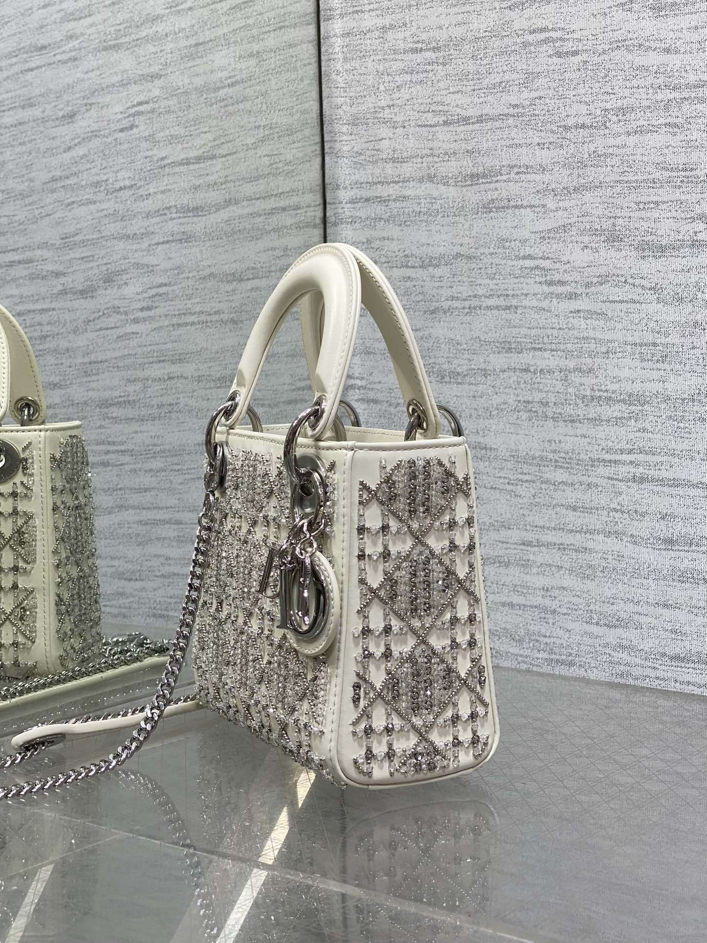 Dior Mini Lady Dior bag is crafted latte-colored beaded lambskin with silver rhinestone