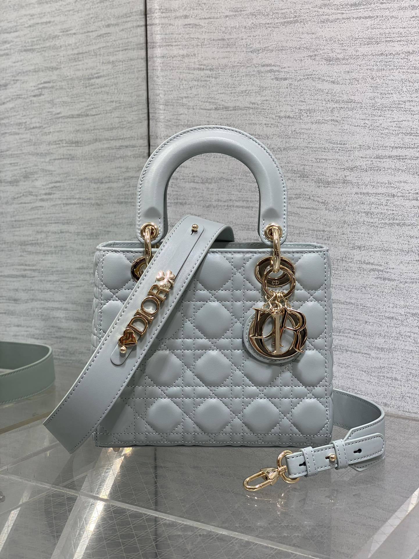 Dior Small Lady Dior My ABCDior Bag typically crafted in cannage lambskin with customizable charms on the strap.