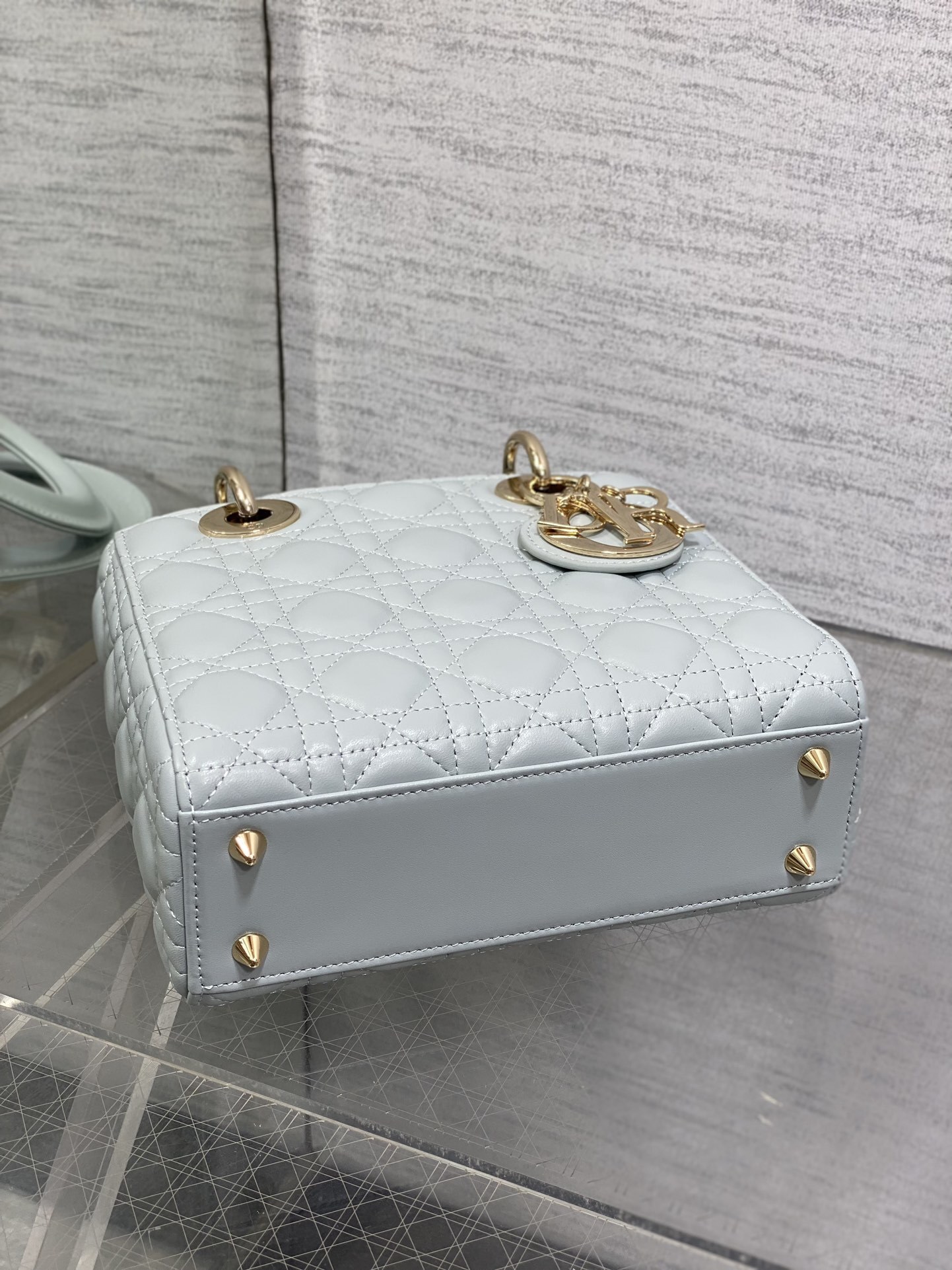 Dior Small Lady Dior My ABCDior Bag typically crafted in cannage lambskin with customizable charms on the strap.