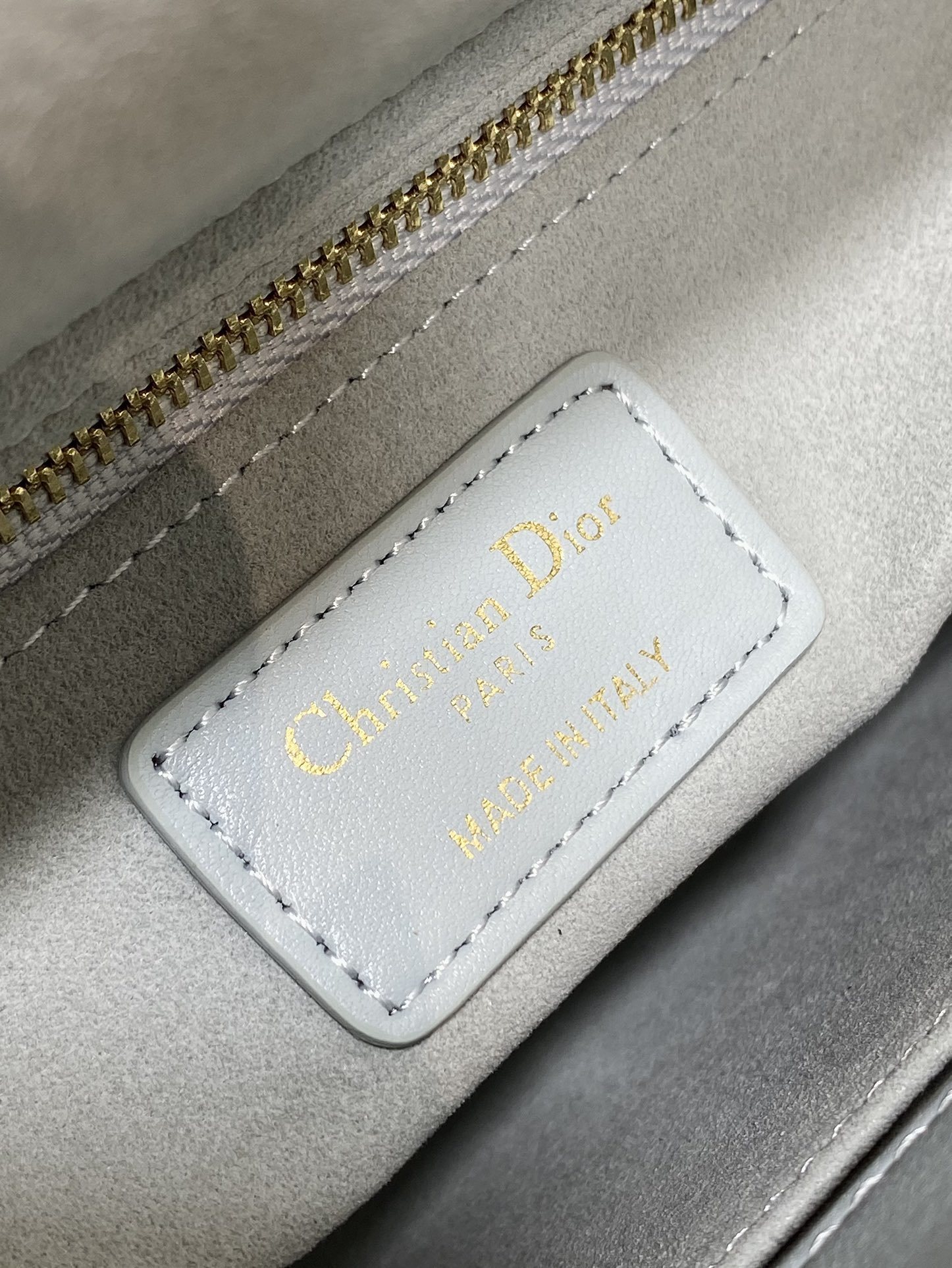 Dior Small Lady Dior My ABCDior Bag typically crafted in cannage lambskin with customizable charms on the strap.