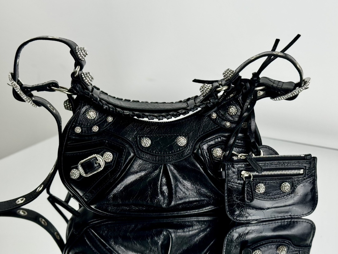 Balenciaga Le Cagole studded shoulder bag, often adorned with rhinestones or metallic studs and featuring a distinct slouchy, moto-inspired shape
