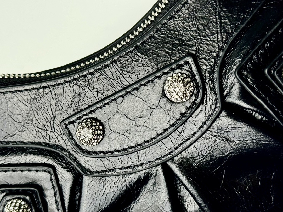 Balenciaga Le Cagole studded shoulder bag, often adorned with rhinestones or metallic studs and featuring a distinct slouchy, moto-inspired shape