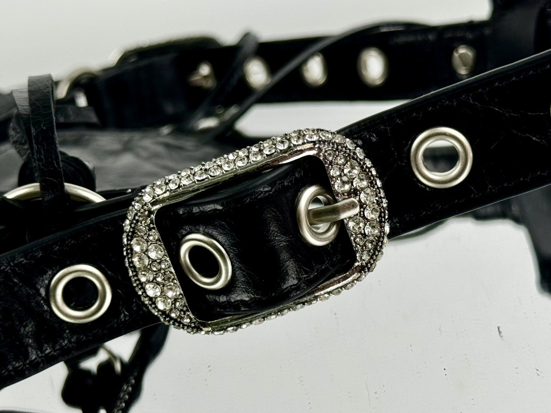 Balenciaga Le Cagole studded shoulder bag, often adorned with rhinestones or metallic studs and featuring a distinct slouchy, moto-inspired shape