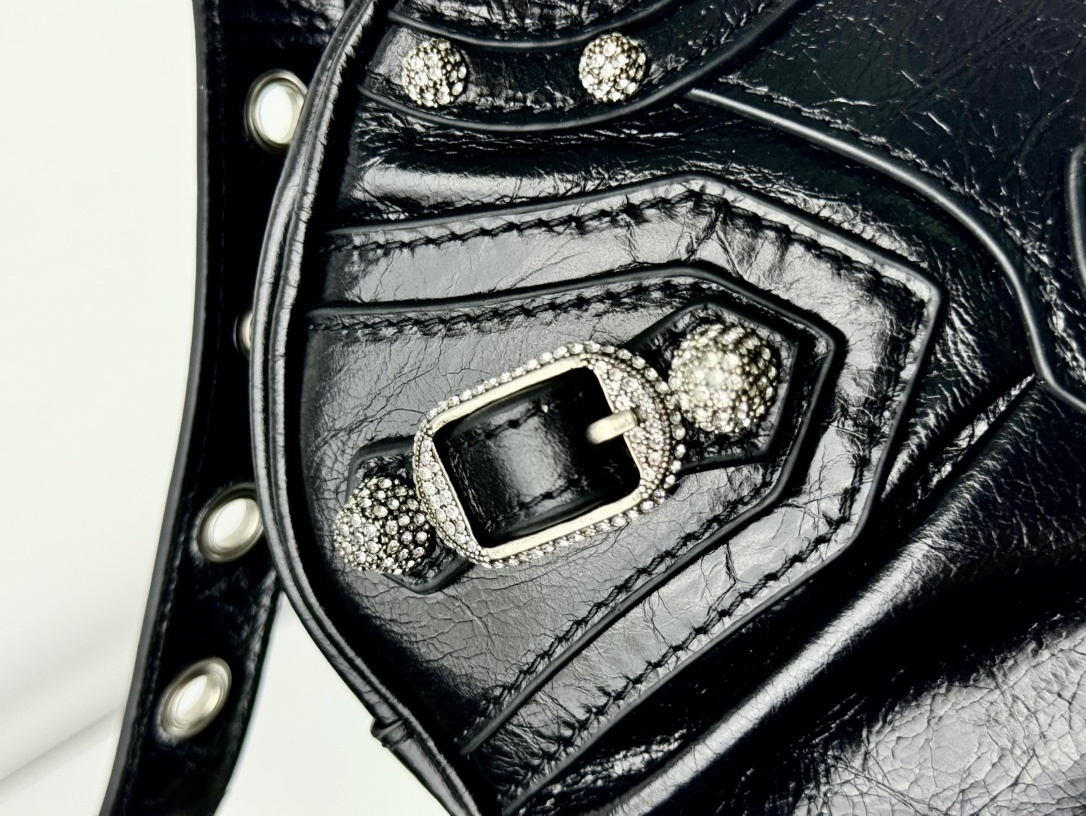 Balenciaga Le Cagole studded shoulder bag, often adorned with rhinestones or metallic studs and featuring a distinct slouchy, moto-inspired shape