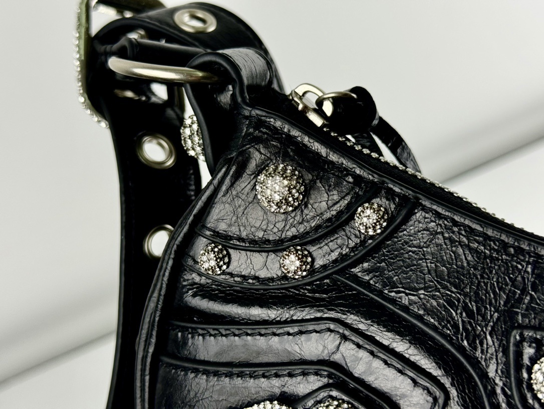 Balenciaga Le Cagole studded shoulder bag, often adorned with rhinestones or metallic studs and featuring a distinct slouchy, moto-inspired shape