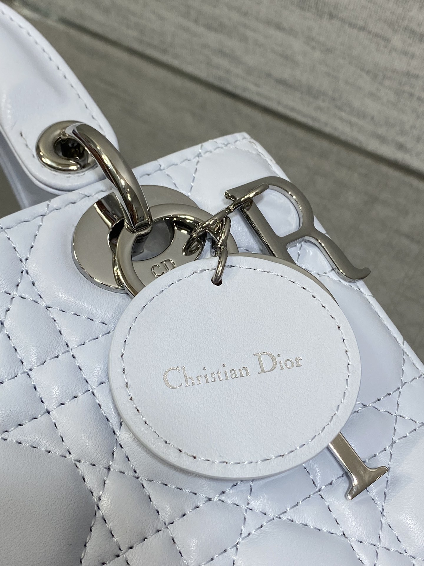 Dior Small Lady Dior Bag in white lambskin, featuring the iconic Cannage quilting pattern and customizable shoulder strap.