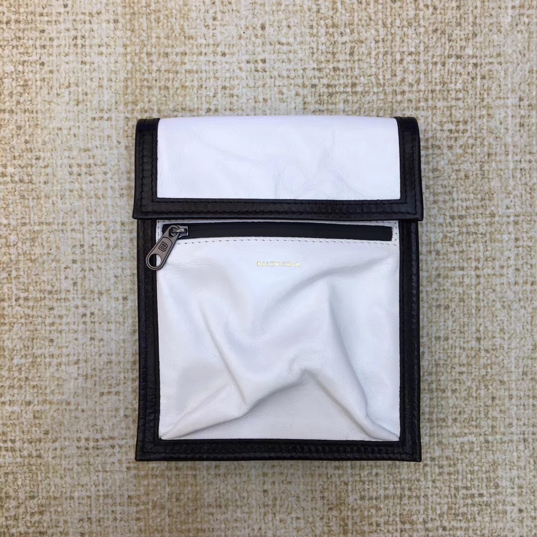 Balenciaga white and black Kenzo phone holder featuring a magnetic closure, an adjustable strap, and an external zip pocket.