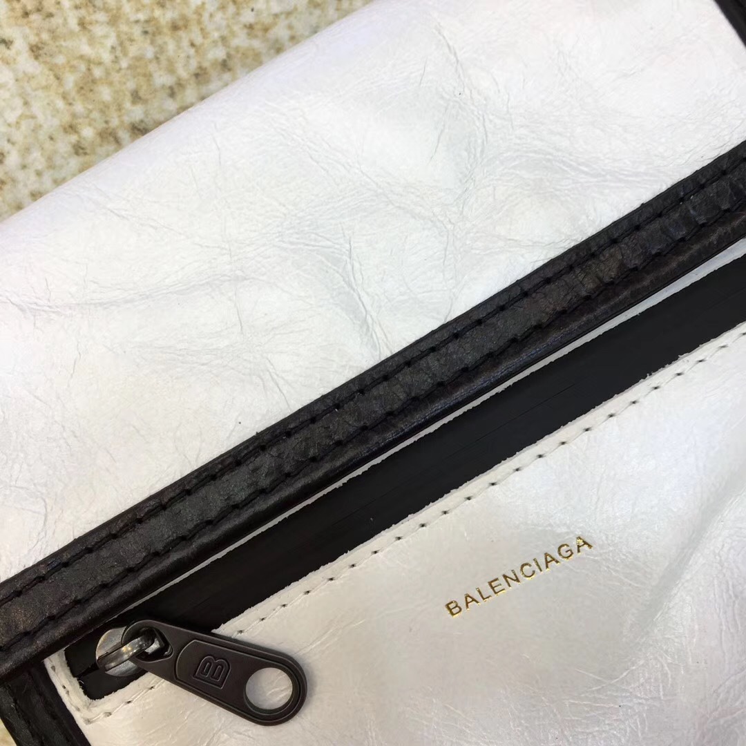 Balenciaga white and black Kenzo phone holder featuring a magnetic closure, an adjustable strap, and an external zip pocket.