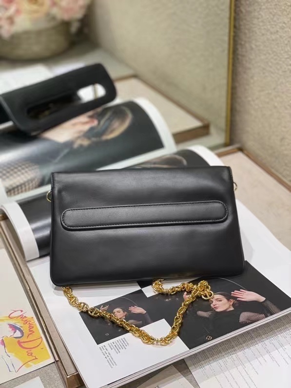 Dior Double bag crafted from black calfskin leather, characterized by its distinctive front flap design and gold-tone hardware