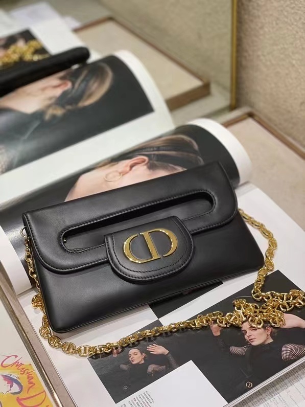 Dior Double bag crafted from black calfskin leather, characterized by its distinctive front flap design and gold-tone hardware