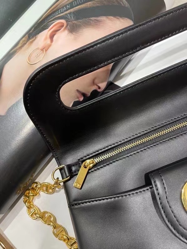 Dior Double bag crafted from black calfskin leather, characterized by its distinctive front flap design and gold-tone hardware